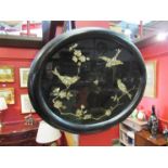 An Oriental mother-of-pearl oval wall hanging tray with scenes of birds and butterflies among