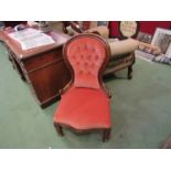 A Victorian walnut buttoned spoon back armchair over a serpentine front seat on turned legs and