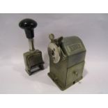 A vintage "Wyna 2" desk mount pencil sharpener and Dormy 3 action number stamp