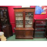 A 1930's Regency style mahogany glazed bookcase,