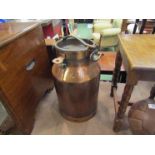 A copper milk churn,