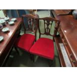 A set of four Victorian carved mahogany dining chairs on ring turned legs