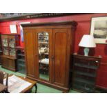 A late Victorian wardrobe with central mirrored door opening to reveal shelf and drawer interior,