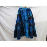 A late 1970's wool floral cape in tones of turquoise, blue and black,