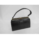 A classic black leather lizard skin handbag