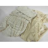 A box of Victorian and Edwardian christening clothing including a cape