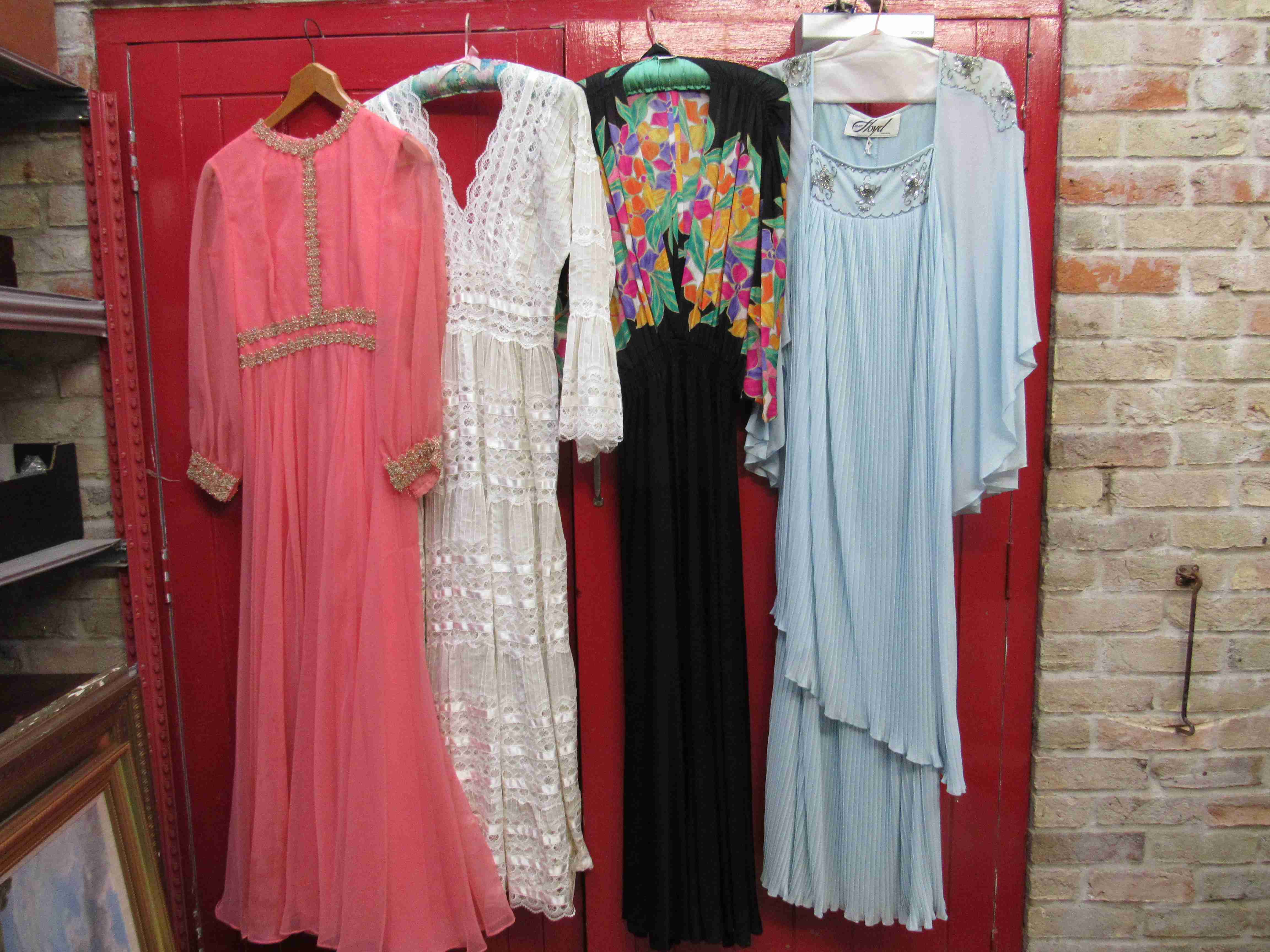 Four 1960's/70's full length evening dresses, salmon pink with gold lace trim, cream lace,