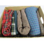 A box of tweeds and tartan fabrics