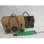 A tapestry effect holdall with hoop handles and black trim,