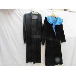 An early 20th Century black velvet eveing coat with blue velvet lining,