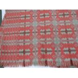 A Welsh blanket in pink grey and mint