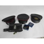 Three bygone uniform hats, a small quantity of uniform buttons, mainly G.P.