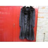 A 1950's/60's dark brown mink fur coat with stylised buttons