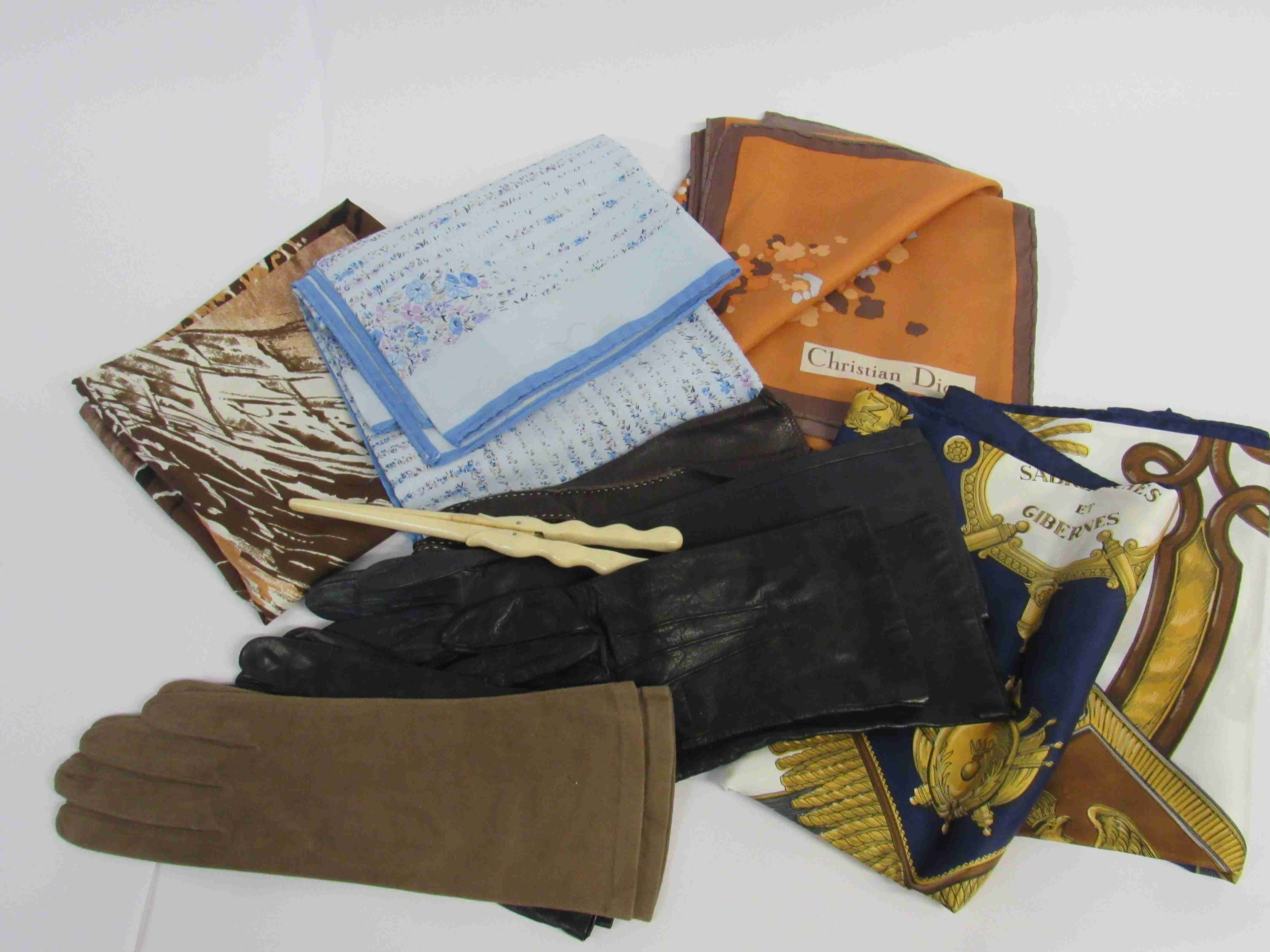 A quantity of fine leather gloves and silk scarves and a glove stretcher