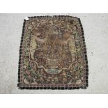 A late 18th Century wool tapestry, vase of flowers, foliage border, fringe edge,