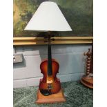 A violin form lamp with shade,