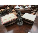 Two late Victorian footstools and a small bronze effect cherub figure