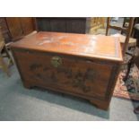 A mid 20th Century Southeast Asia camphor wood trunk with carved decoration and sliding tray (with