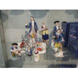 Nine Continental ceramic figures including lady and gent with sheep