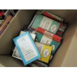 Two boxes containing a large collection of Penguin and Pelican paperback books on various subjects