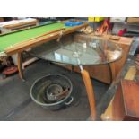 A modern glass topped oval dining table