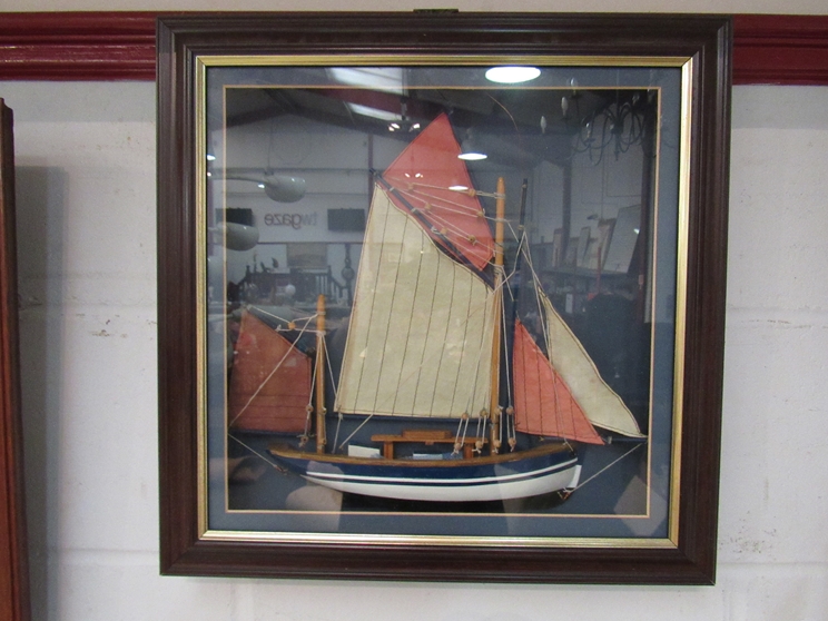 A framed diorama of a ship