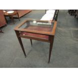 An Edwardian satinwood and mahogany line inlaid display case with baize interior on castors,