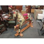 WITHDRAWN - A painted dapple Collinson early 20th Century rocking horse on trestle rocker,