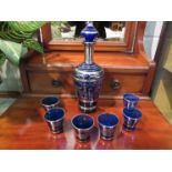 A Bristol blue glass decanter for liqueur and six matching shot glasses with allover metallic