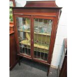 An Edwardian mahogany line inlaid cabinet with astragal glazed doors and raised gallery back,