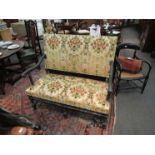 An 18th Century ebonised carved walnut two seater country house sofa on turned supports and