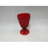A pressed water goblet, the ruby red bowl with raised decoration,