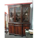 An astragal glazed top over three drawer three door cupboard base bookcase,