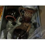 A box containing glazed jugs,