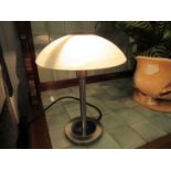 A touch lamp with opaque glass shade