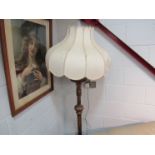 A gilded standard lamp with shade