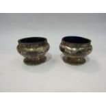 A pair of silver salts with blue glass liners