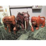 Two hardwood carved elephants and a lion