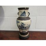 A Chinese vase with warriors on horseback, character marks to base, on carved hardwood stand,