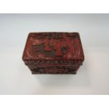 A Chinese 19th Century carved red cinnabar hinged box, black lacquer interior and base,