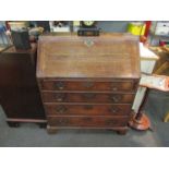 A circa 1780 oak bureau, the fitted interior over four long drawers on bracket feet, with key,