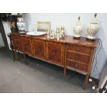 A modern burr wood sideboard, three cupboard doors flanked by six drawers, leg a/f, 214cm long,