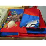 A box of silk Oriental embroidered cushion covers (11) and a pair of curtain tie-backs
