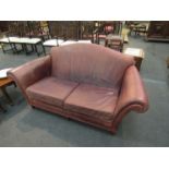 A brown leather two seater sofa