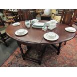 An 18th Century and later oval top drop leaf dining table with single end cutlery drawer over