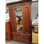 A Victorian walnut single wardrobe, the mirror door with key over a single base drawer,