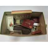 A box of mixed collectibles including lighters