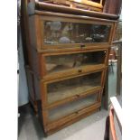 An oak Globe-Wernicke & Co of London four tier stacking bookcase with glazed doors,