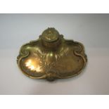 A brass floral design inkwell with ceramic bowl