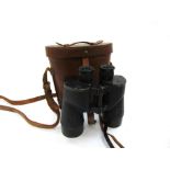 A pair of WWII era binoculars with broad arrow marks and leather case,